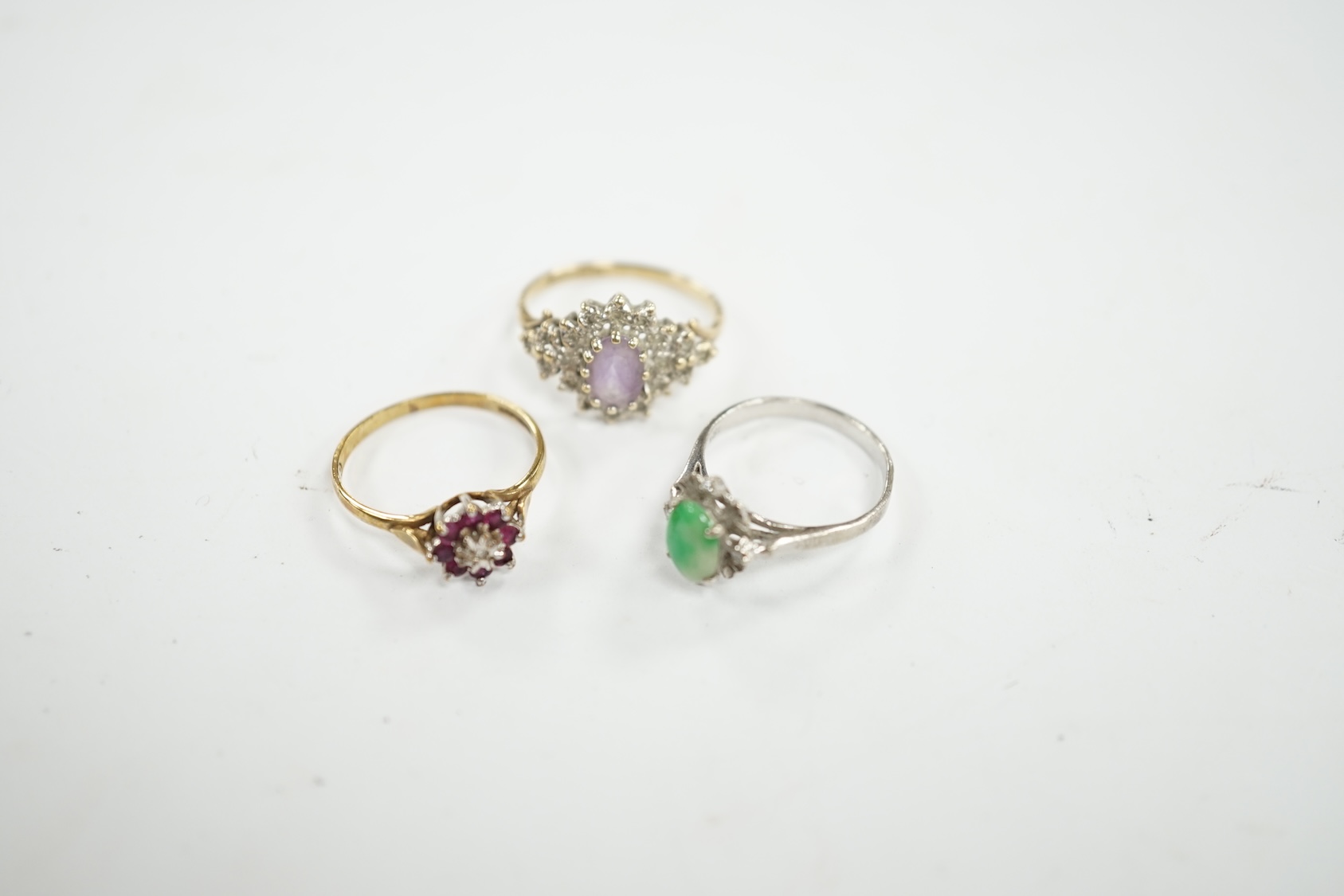 A mid 20th century 18k, jade and diamond cluster set ring, size I, gross weight 1.5 grams, together with two modern 9ct gold and gem set rings, gross weight 3.2 grams. Condition - fair